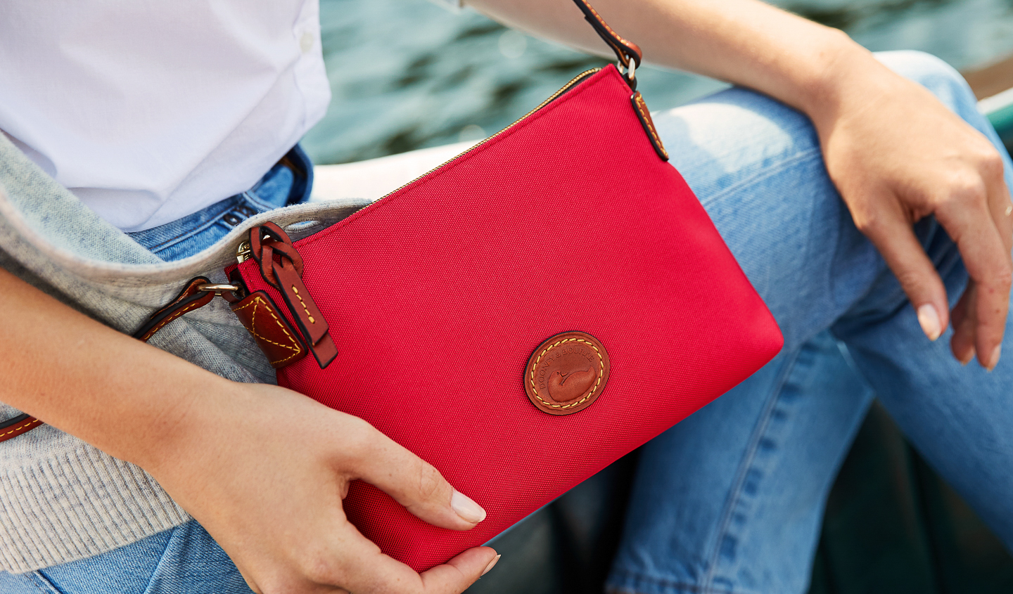 Dooney & Bourke: Crossbody Pouchette in the color Navy & Nylon